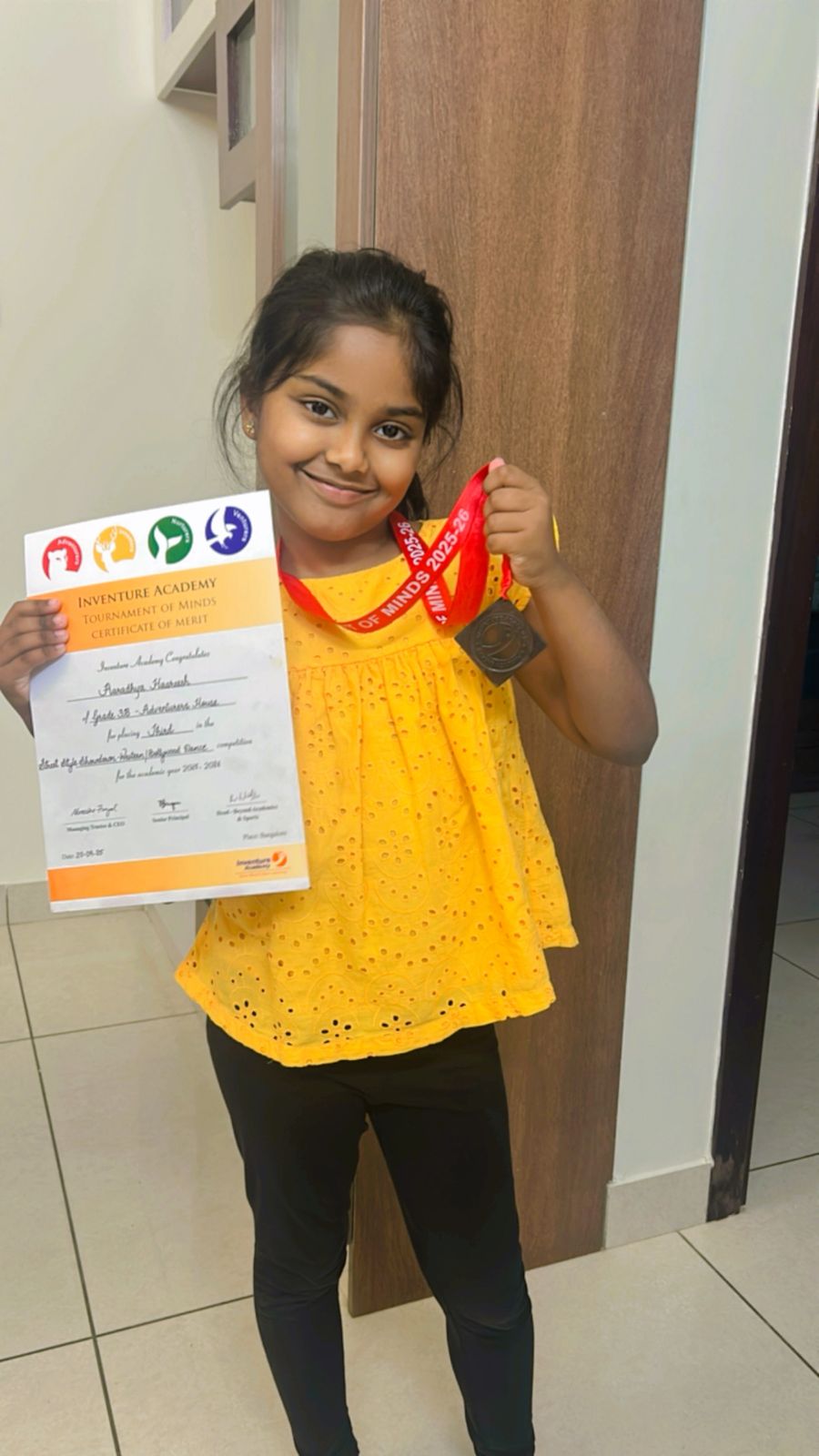Student with medal and certificate